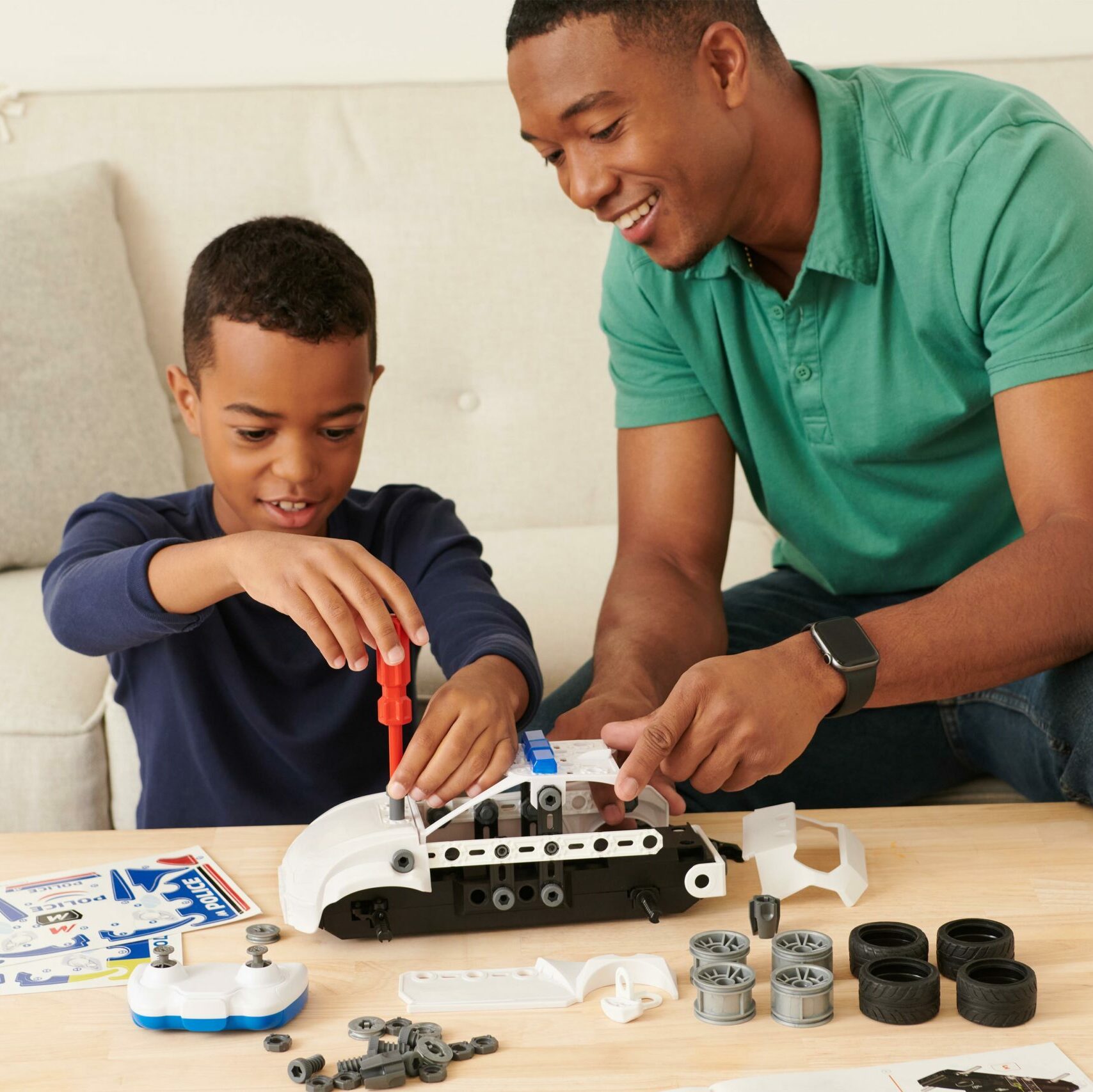 Father and son building a Meccano toy.