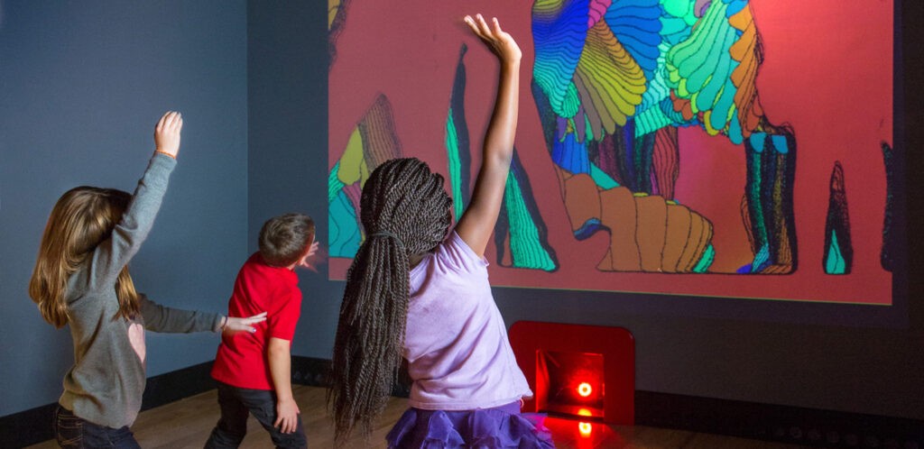 Kids dancing with interactive screen