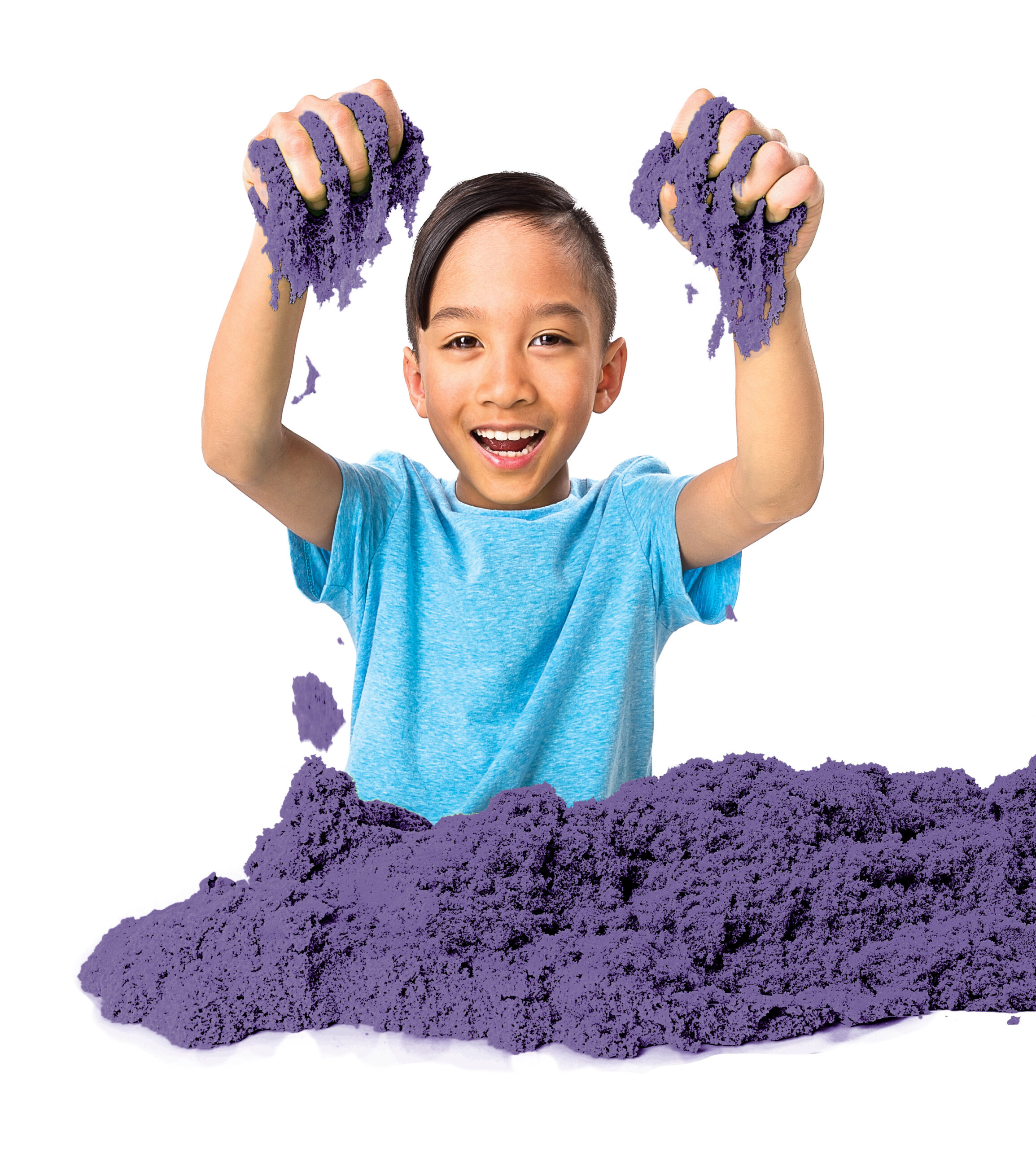 kid playing with purple kinetic sand.