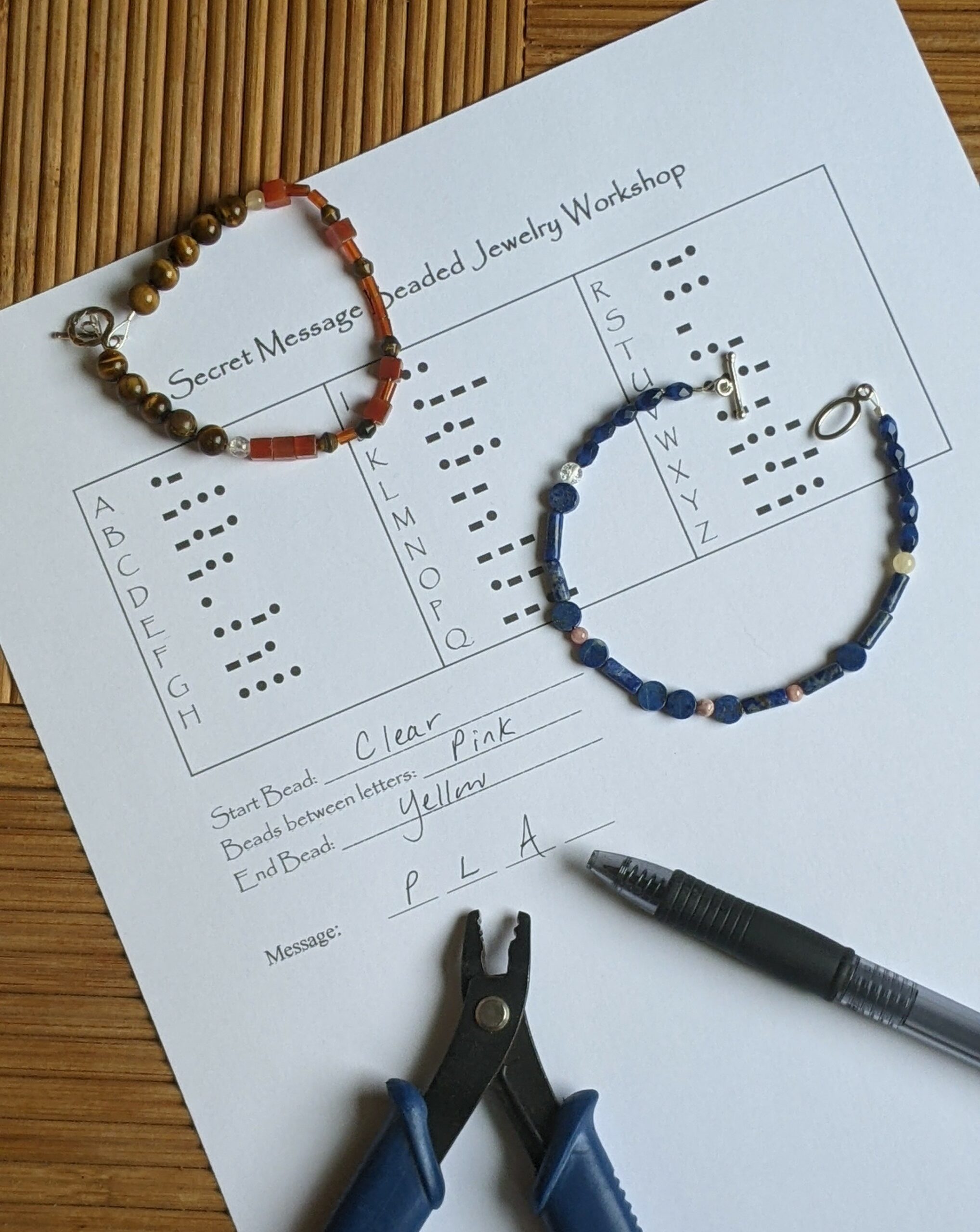 Bracelets and bracelet-making tools on top of a secret message decoding page