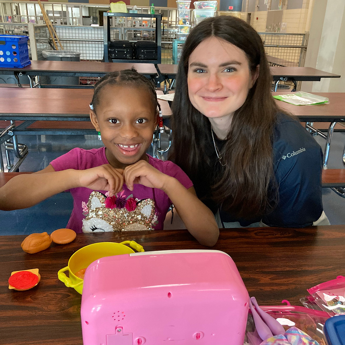 Girl and volunteer playing